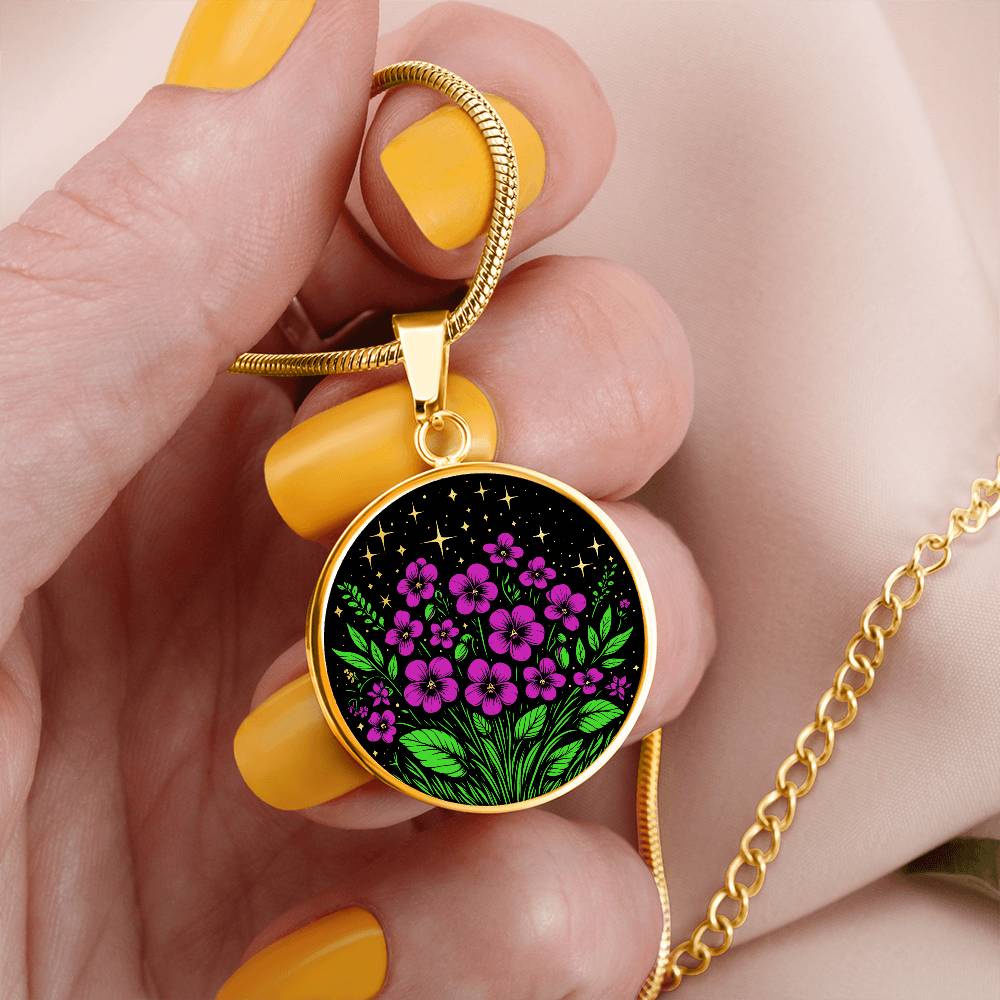 Woman holding an Elegant gold pendant featuring a vivid Purple African Violet Birth Flower Necklace with green grass, gold stars set against a Black backdrop. This jewelry offers personalization with an engraving option for a name.
