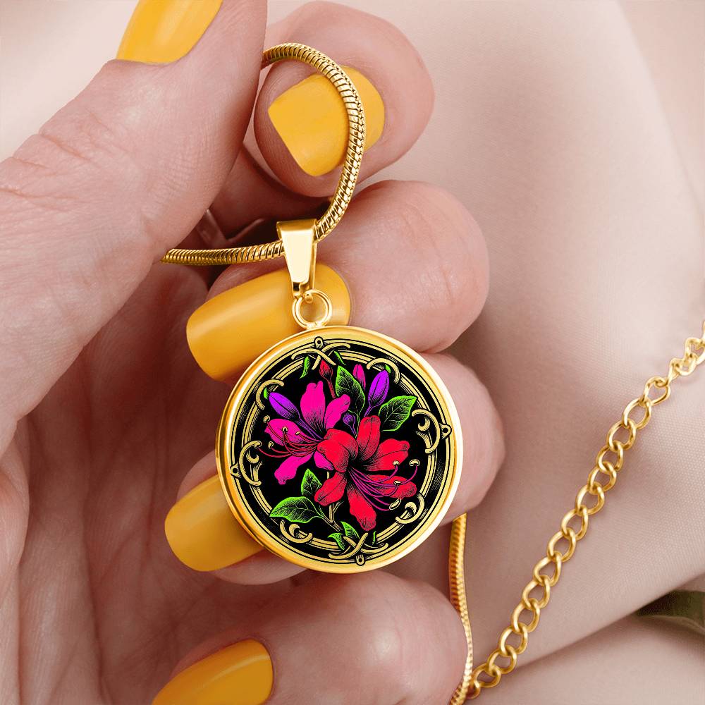Woman holding an Elegant gold pendant featuring a vivid red, Pink & Purple honeysuckles, Junes birth month flower, set against a black backdrop with the metal shinning through. This necklace offers personalization with an engraving option for a name