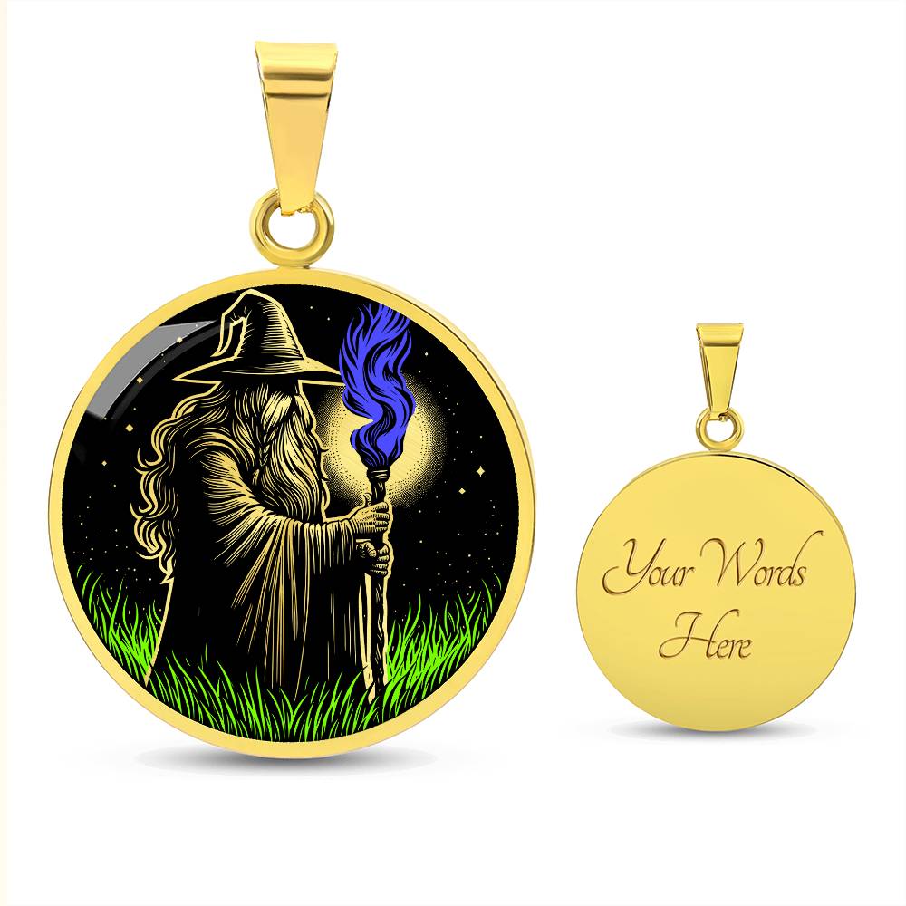 An Elegant gold pendant featuring a Fantasy Wizard Necklace, with green grass, blue fire with a gold and black background. This jewelry offers personalization with an engraving option for a name.