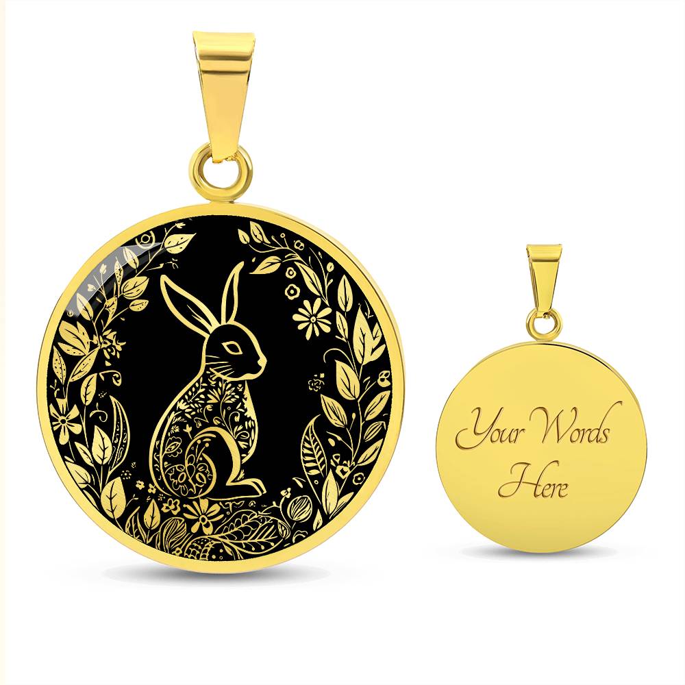 an Elegant gold pendant Easter Bunny necklace featuring Silver bunny with leaves and flowers all in gold with a black background. This jewelry offers personalization with an engraving option for a name.