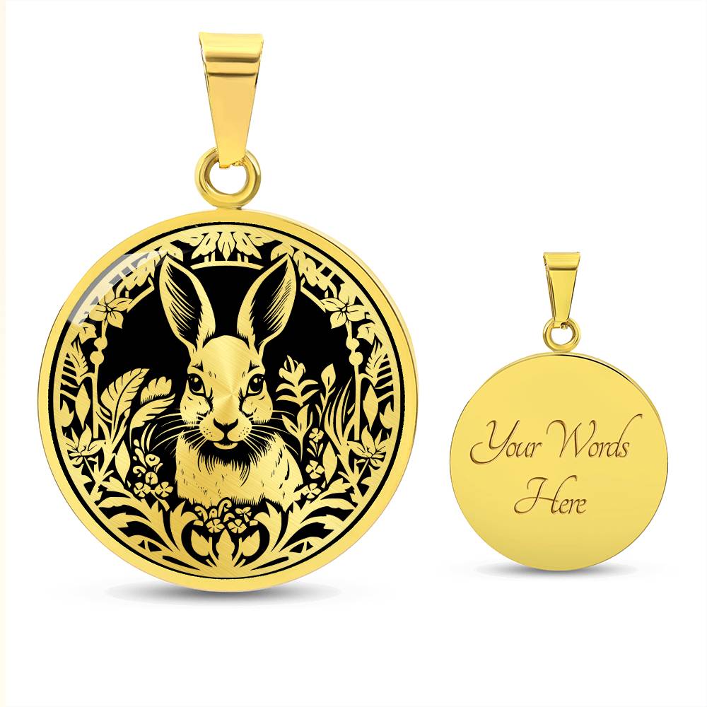 Elegant gold pendant featuring a Rabbit silhouette, The rabbit is hiding in the grass, set against a black backdrop. This necklace offers personalization with an engraving option for a name.