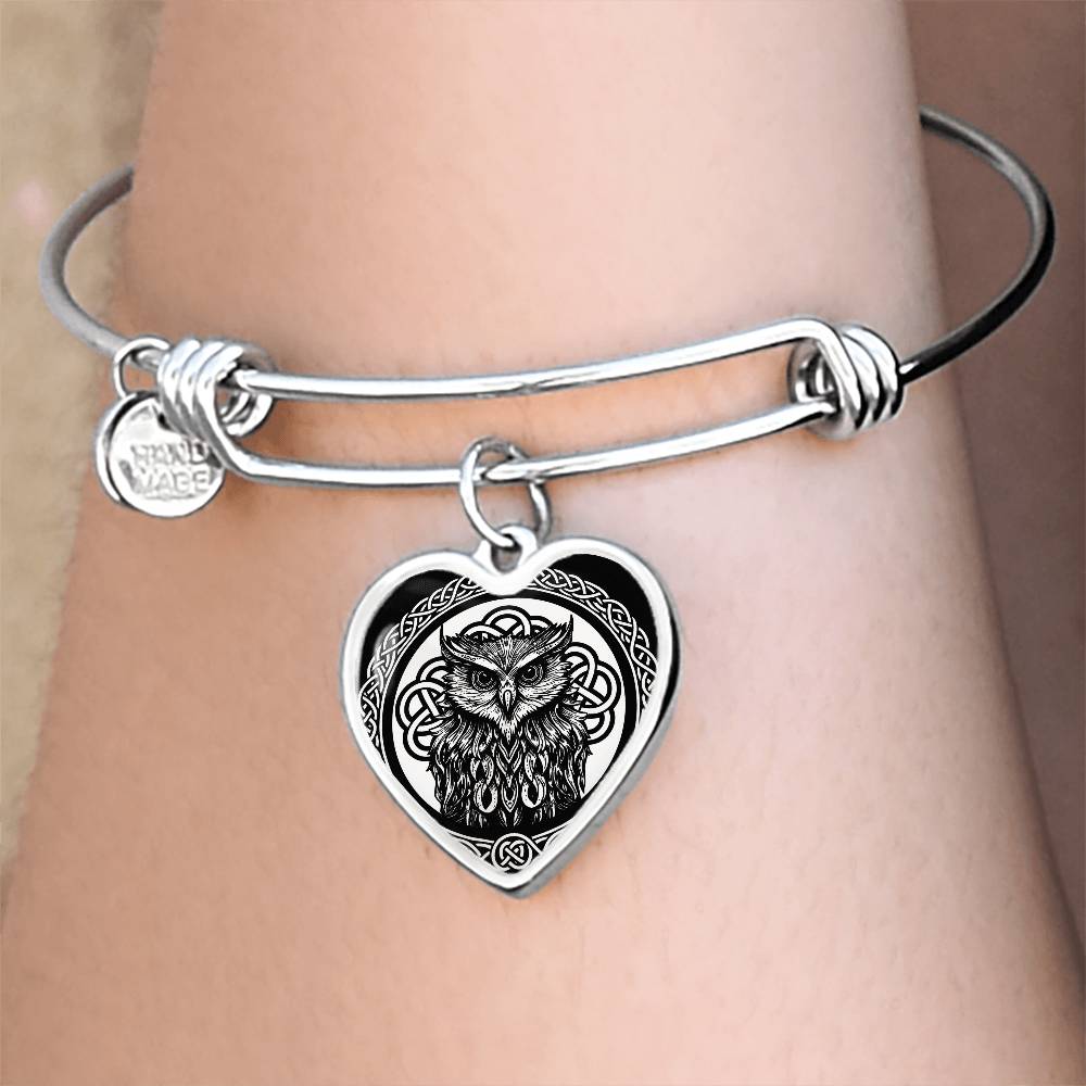 Woman wearing an elegant silver pendant Celtic Owl Bracelet. Colors are silver and black. This jewelry offers personalization with an engraving option for a name.
