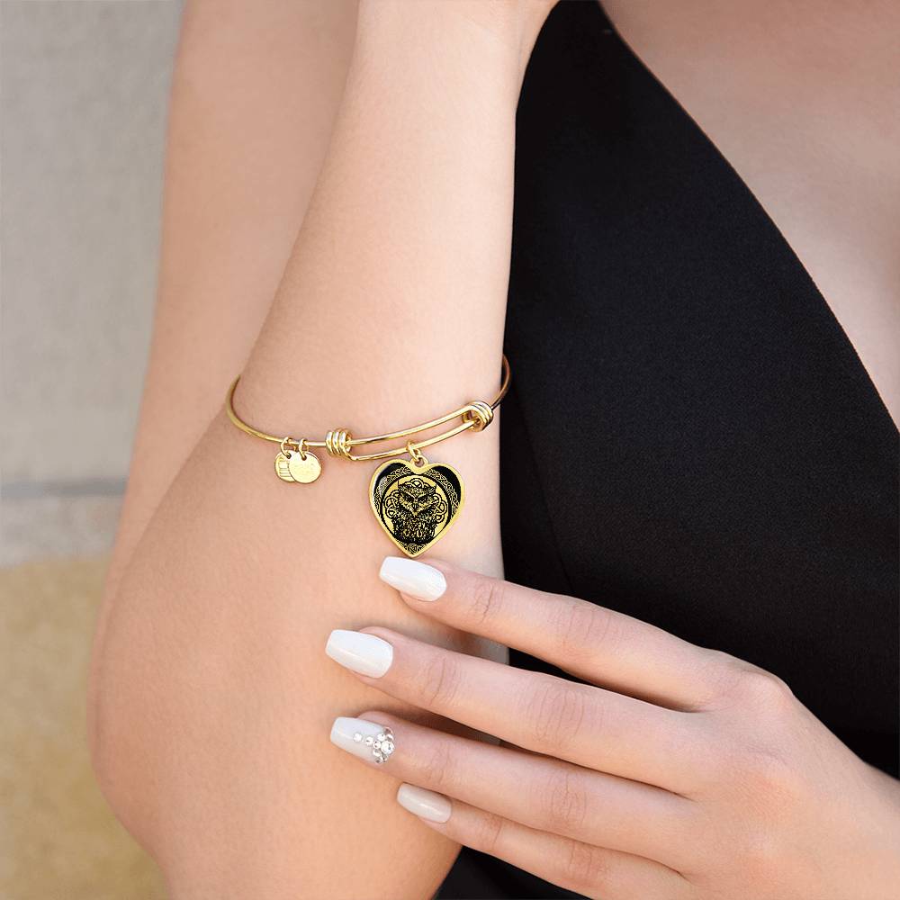Woman wearing an elegant gold pendant Celtic Owl Bracelet. Colors are gold and black. This jewelry offers personalization with an engraving option for a name.