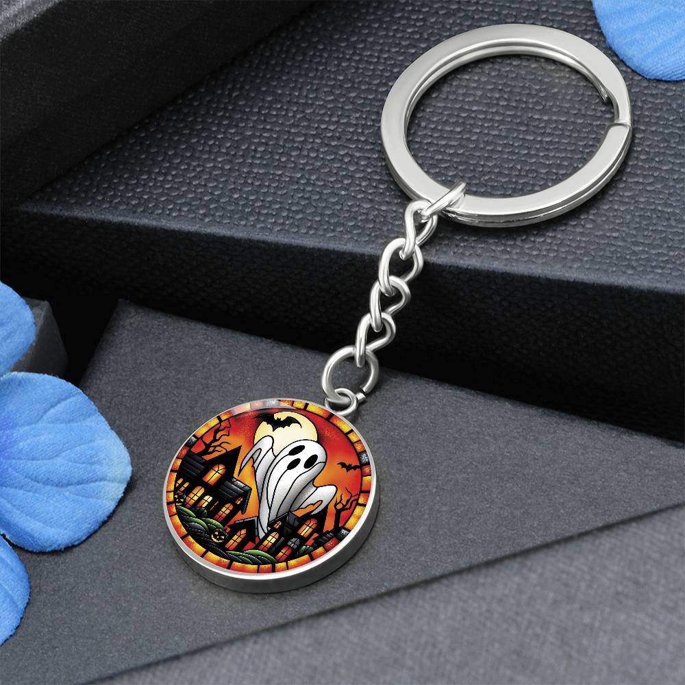 An elegant silver pendant Halloween Ghost Keychain. The colors are white, black, yellow, orange and green. This jewelry offers personalization with an engraving option for a name.