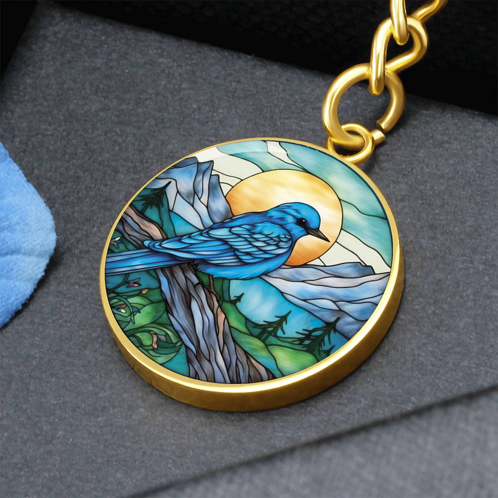 An elegant gold pendant Bluebird Necklace. The colors are blue, green, brown and yellow. This jewelry offers personalization with an engraving option for a name.