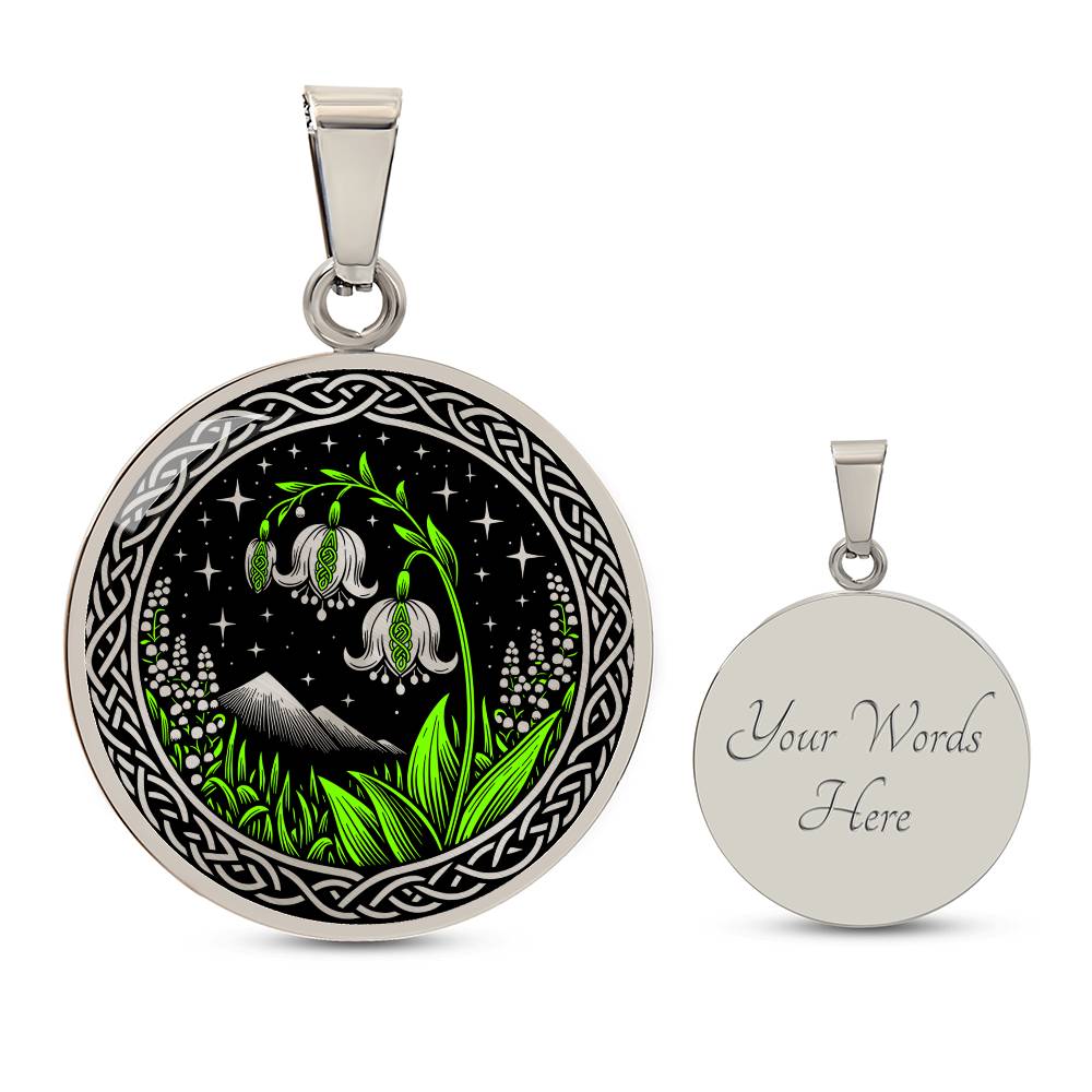 An Elegant silver pendant Celtic Lily Of The Valley Necklace featuring Green Grass, Silver Mountains, Stars,  Lily Of The Valleys, Celtic Knot Frame with a black backdrop. This jewelry offers personalization with an engraving option for a name.