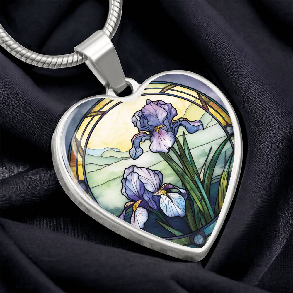 Silver Heart Pendant Purple Iris flower necklace, With green grass, a Yellow sunset and Green mountains. This necklace offers personalization option for a name.