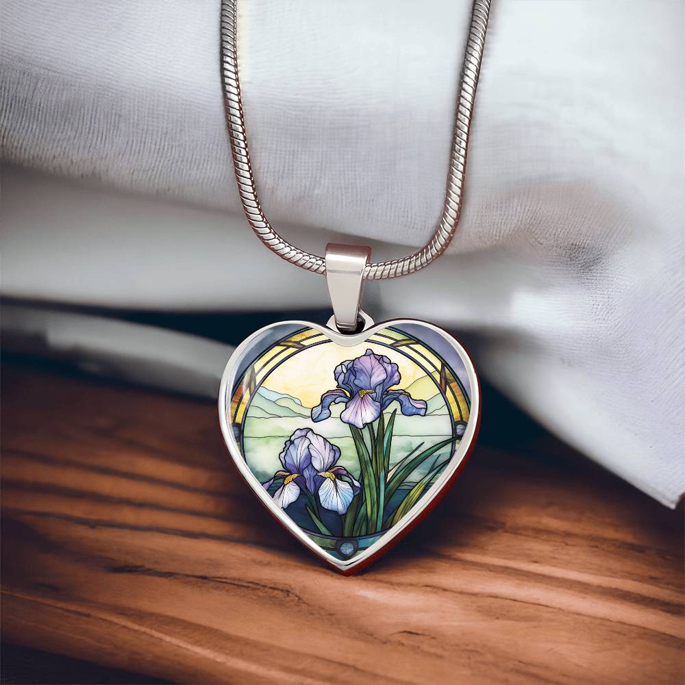 Silver Heart Pendant Purple Iris flower necklace, With green grass, a Yellow sunset and Green mountains. This necklace offers personalization option for a name.