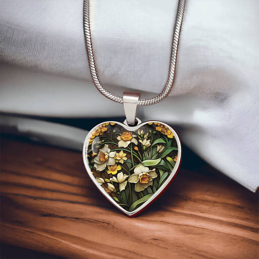 an Elegant silver pendant featuring a yellow/white Daffodil Birth Flower Necklace, March birth month flower, set against a Green & brown backdrop. This jewelry offers personalization with an engraving option for a name.