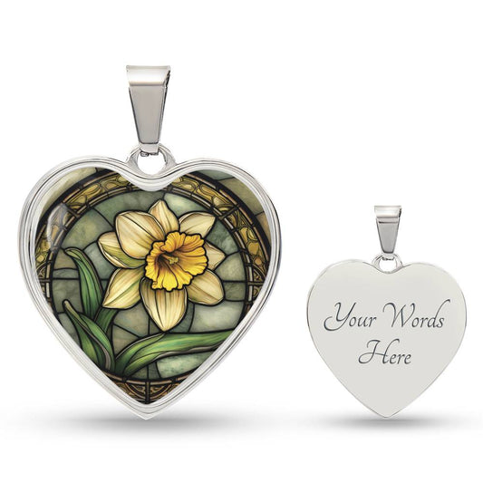 an Elegant silver pendant featuring a vivid Daffodil Birth Flower Necklace, March birth month flower, set against a Green & Tan backdrop. This jewelry offers personalization with an engraving option for a name.