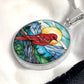An Elegant silver pendant Red Bird Necklace. featuring a Sunny blue sky with mountains, blue lake and green forest. This jewelry offers personalization with an engraving option for a name.