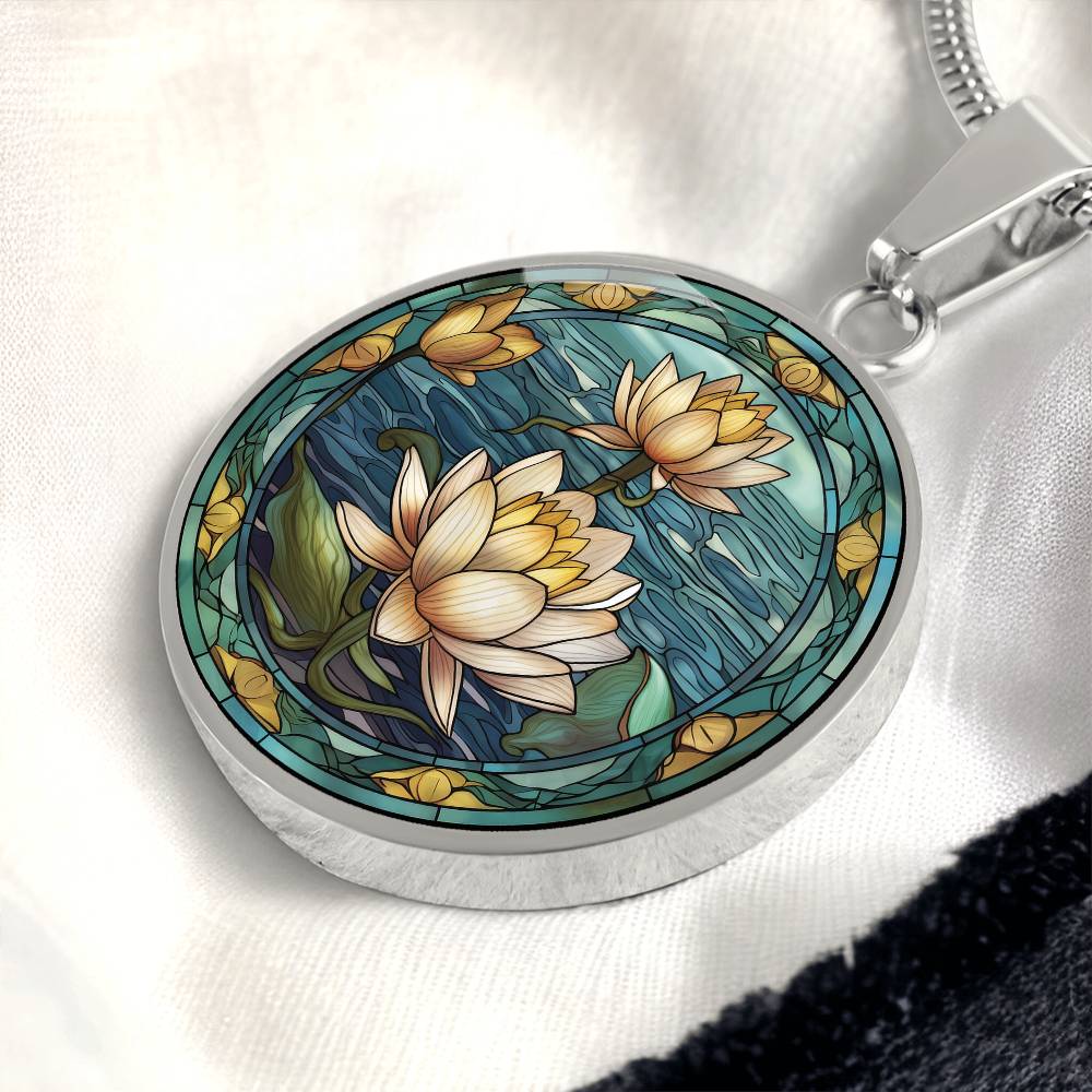 an elegant silver pendant Water Lily Necklace. The colors are Green Leaves, Blue Water and Tan Flowers. This jewelry offers personalization with an engraving option for a name.