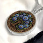 an elegant silver pendant Aster Celtic Tree of Life Necklace. The Colors are blue, green, brown and black. This jewelry offers personalization with an engraving option for a name.