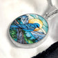 an Elegant silver pendant Blue Bird necklace. Colors blue bird and water, yellow sun, green trees and grass, brown branch, blue and white sky/ mountains. This jewelry offers personalization with an engraving option for a name.