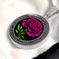 An Elegant January Silver pendant Celtic Birth Flower Carnation Necklace. Featuring a vivid pink flower with green leaves, set against a Silver & black backdrop. This jewelry offers personalization with an engraving option for a name.