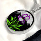 Februarys birth month flower Elegant silver pendant featuring a vivid Purple Iris Necklace set against a Green Grass, Silver moon and mountains background. This necklace offers personalization option for a name.