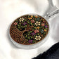 an elegant silver pendant Honeysuckle Celtic Tree of Life Necklace. The Colors are yellow, white, pink, purple, green, brown and black. This jewelry offers personalization with an engraving option for a name.