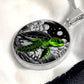 Elegant silver pendant featuring a vivid Green Turtle Necklace with a moon, Stars, Clouds and Ocean set against a black  backdrop. This jewelry offers personalization with an engraving option for a name.