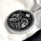 An Elegant silver pendant featuring a Year of the Ram/Sheep and Year of The Dragon Necklace in silver and black. This jewelry offers personalization with an engraving option for a name.