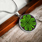 Elegant Silver pendant necklace featuring a vivid Celtic four leaf clover with four red & Green hearts, set against a subtle Black & silver backdrop. This jewelry offers personalization with an engraving option for a name.