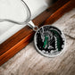 an Elegant silver pendant Chinese Dragon necklace featuring a vivid Jade dragon with stars and clouds set against a black backdrop. This jewelry offers personalization with an engraving option for a name.