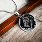 an Elegant silver pendant Chinese Dragon necklace featuring a vivid silver dragon with stars and clouds set against a black backdrop. This jewelry offers personalization with an engraving option for a name.