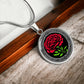 an Elegant January Silver pendant Celtic Carnation Birth Flower necklace featuring a vivid red, green flower, set against a Silver & black backdrop. This jewelry offers personalization with an engraving option for a name.