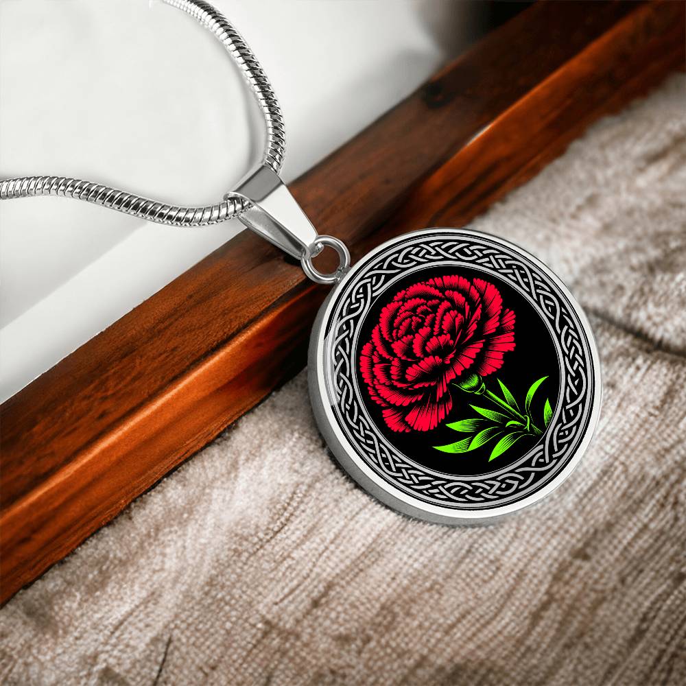 an Elegant January Silver pendant Celtic Carnation Birth Flower necklace featuring a vivid red, green flower, set against a Silver & black backdrop. This jewelry offers personalization with an engraving option for a name.