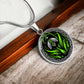Elegant silver pendant featuring a vivid Snowdrop Birth Flower Necklace, January birth month flower, set against a Green & Black backdrop with a Celtic border. This jewelry offers personalization with an engraving option for a name.