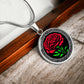 An elegant Celtic silver pendant  January Birth Flower Carnation necklace featuring a vivid red carnation, green stem and leaves, set against a silver & black backdrop. This jewelry offers personalization with an engraving option for a name.