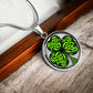Elegant silver pendant necklace featuring a vivid Green Celtic Clover set against a silver & black backdrop. This necklace offers personalization with an engraving option for a name.