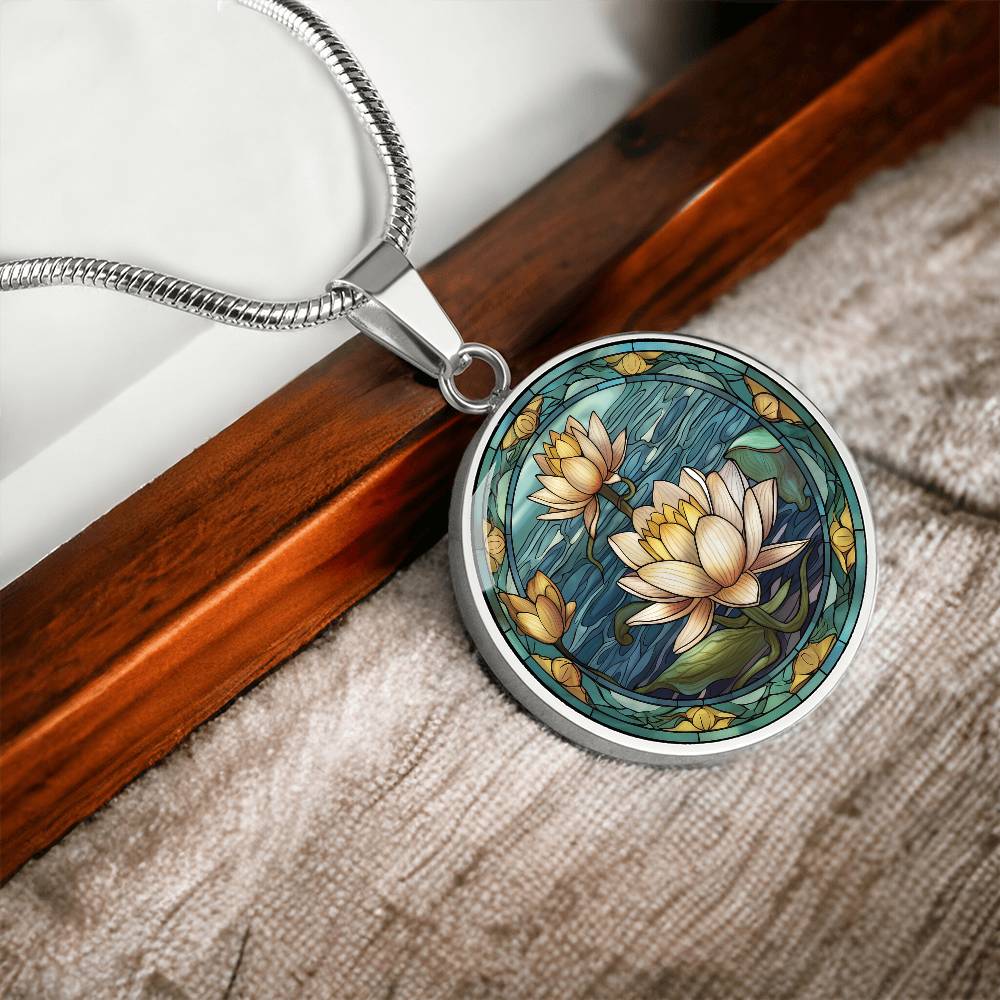 an elegant silver pendant Water Lily Necklace. The colors are Green Leaves, Blue Water and Tan Flowers. This jewelry offers personalization with an engraving option for a name.