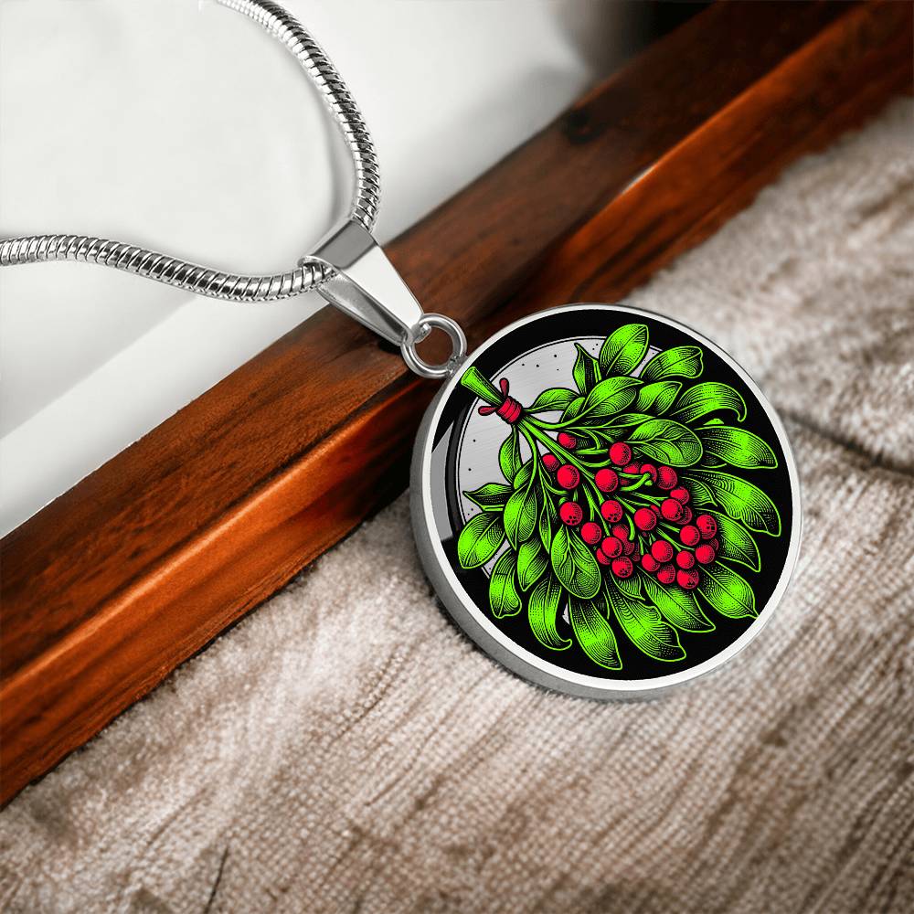 Elegant silver pendant necklace featuring a vivid Mistletoe with red berries set against a silver & black backdrop. This necklace offers personalization with an engraving option for a name.