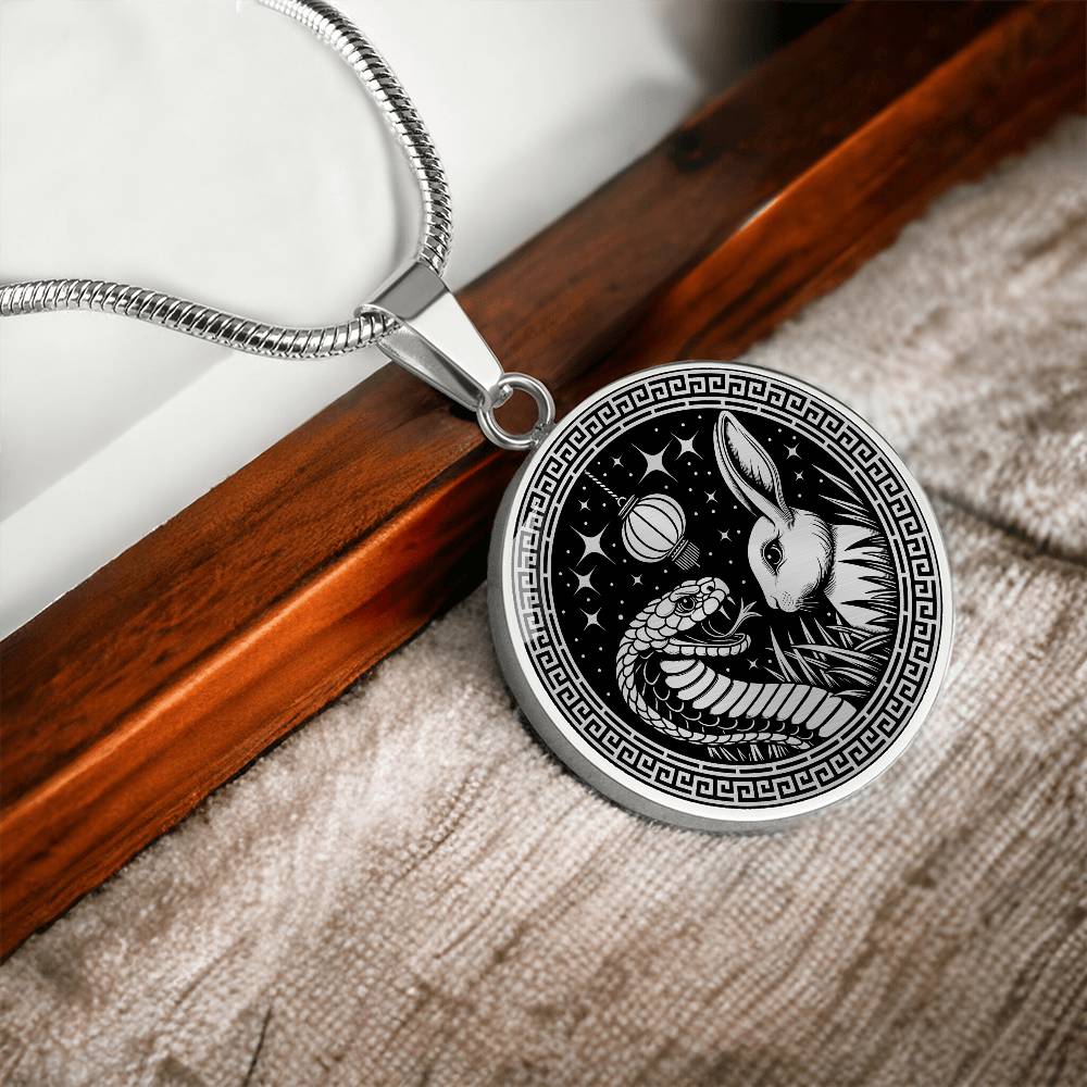 An Elegant silver pendant featuring a Year of the Rabbit and Year of The Snake Necklace in silver and black. This jewelry offers personalization with an engraving option for a name.