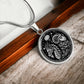 An Elegant silver pendant featuring a Year of the Ram/Sheep and Year of The Dragon Necklace in silver and black. This jewelry offers personalization with an engraving option for a name.
