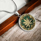 an Elegant silver pendant Weed Leaf necklace featuring a Green and Gold Marijuana Leaf. This jewelry offers personalization with an engraving option for a name.