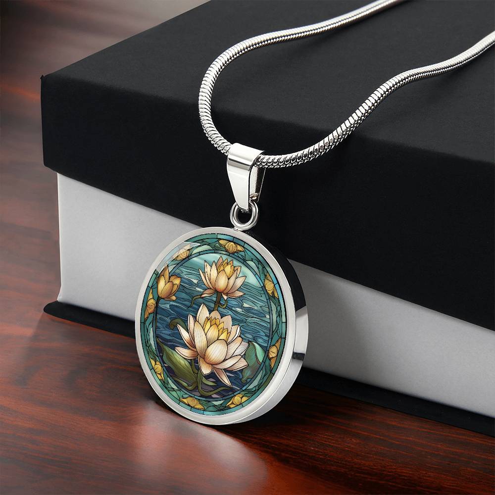 Gift box with an elegant silver pendant Water Lily Necklace. The colors are Green Leaves, Blue Water and Tan Flowers. This jewelry offers personalization with an engraving option for a name.