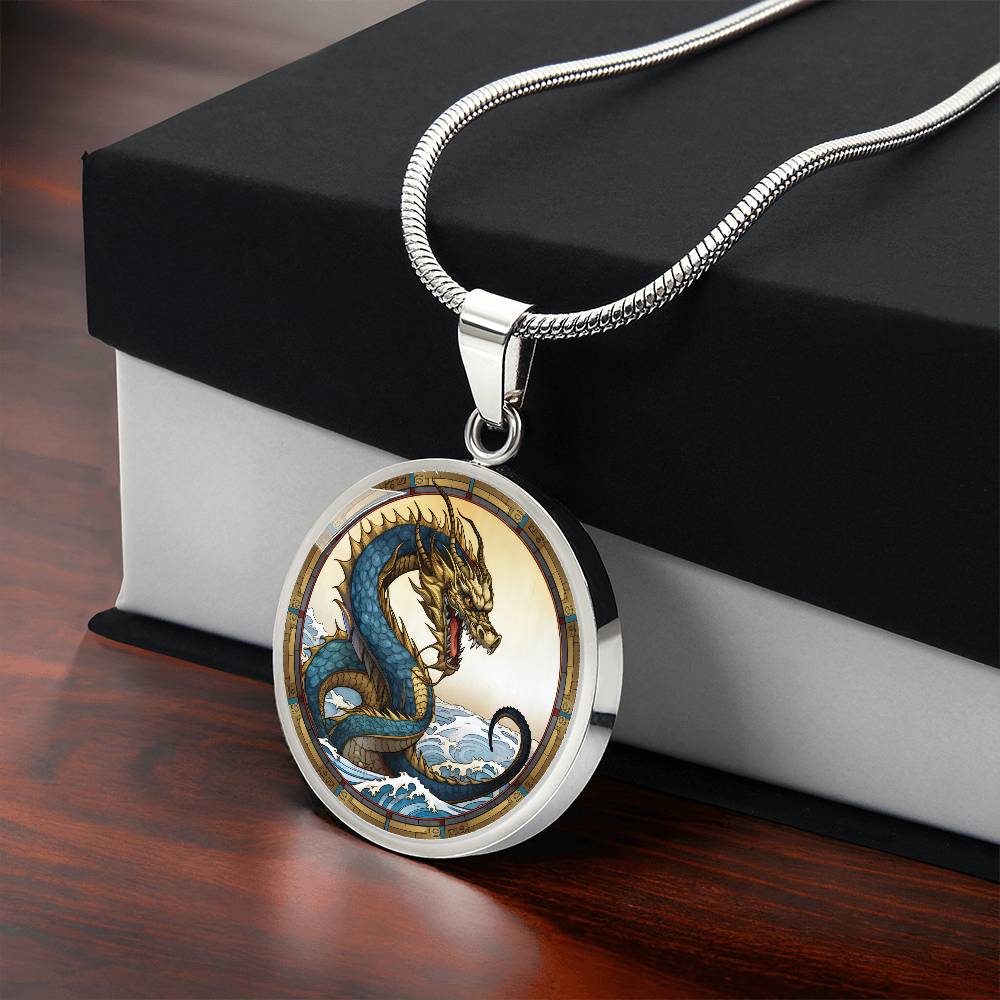 Gift box with An Elegant silver pendant featuring a Water Dragon Necklace. Blue and yellow Dragon with a blue ocean, tan border and backdrop. This jewelry offers personalization with an engraving option for a name.