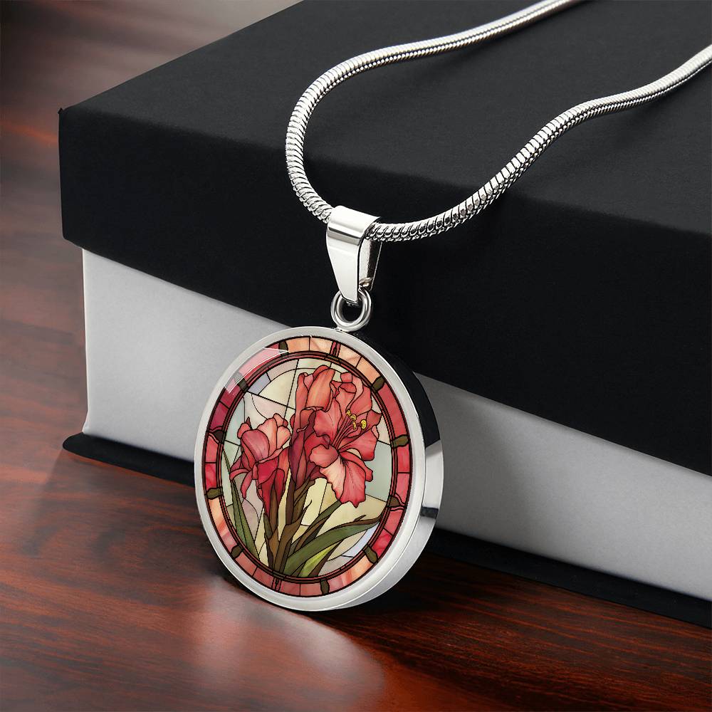 Gift box with an elegant silver pendant Gladiolus Necklace. The colors are tan/green/blue/purple background, red and pink flowers, green grass, red border. This jewelry offers personalization with an engraving option for a name.