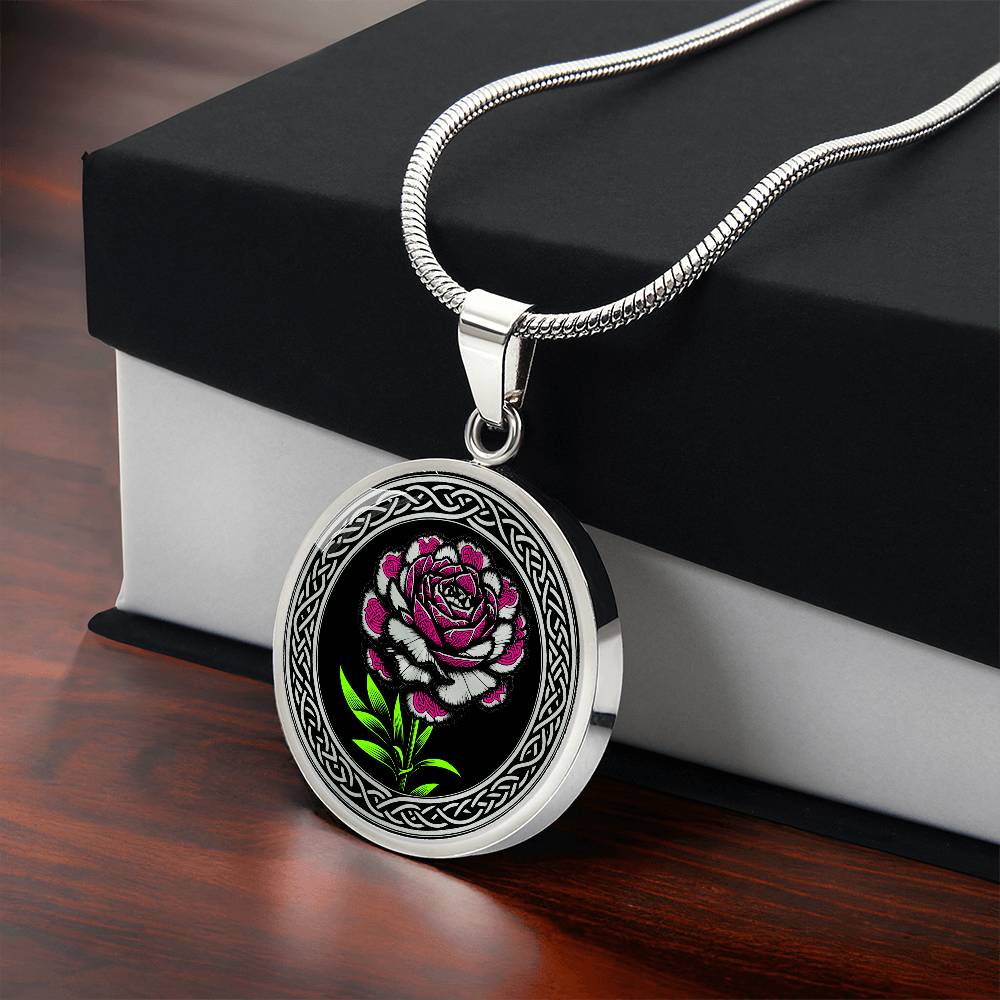 Gift box with an an Elegant January silver pendant Celtic Carnation Birth Flower necklace featuring a vivid pink, green and silver flower, set against a black backdrop. This jewelry offers personalization with an engraving option for a name.