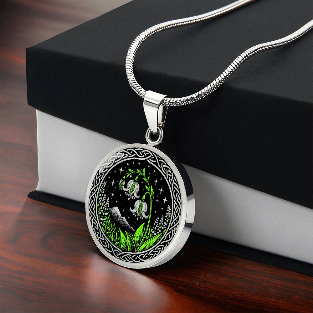 Gift box An Elegant silver pendant Celtic Lily Of The Valley Necklace featuring Green Grass, Silver Mountains, Stars,  Lily Of The Valleys, Celtic Knot Frame with a black backdrop. This jewelry offers personalized engraving option for a name.