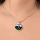 Woman wearing a Februarys birth month flower Elegant silver pendant featuring a vivid Purple Iris Necklace set against a Green Grass, Silver moon and mountains background. This necklace offers personalization option for a name.