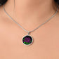 woman wearing an Elegant silver pendant featuring a vivid Purple African Violet Birth Flower Necklace with green grass, silver stars set against a Black backdrop. This jewelry offers personalization with an engraving option for a name.