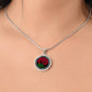 Woman wearing an elegant Celtic silver pendant January Birth Flower Carnation necklace. A vivid red carnation, green stem & leaves, set against a silver & black backdrop. This jewelry offers personalization with an engraving option for a name.