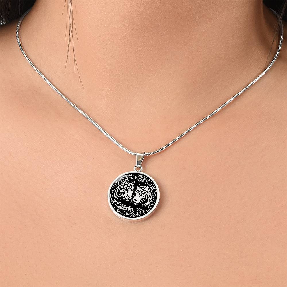 Woman wearing an elegant silver pendant Year of the Tiger Necklace. The colors are silver and black. This jewelry offers personalization with an engraving option for a name.