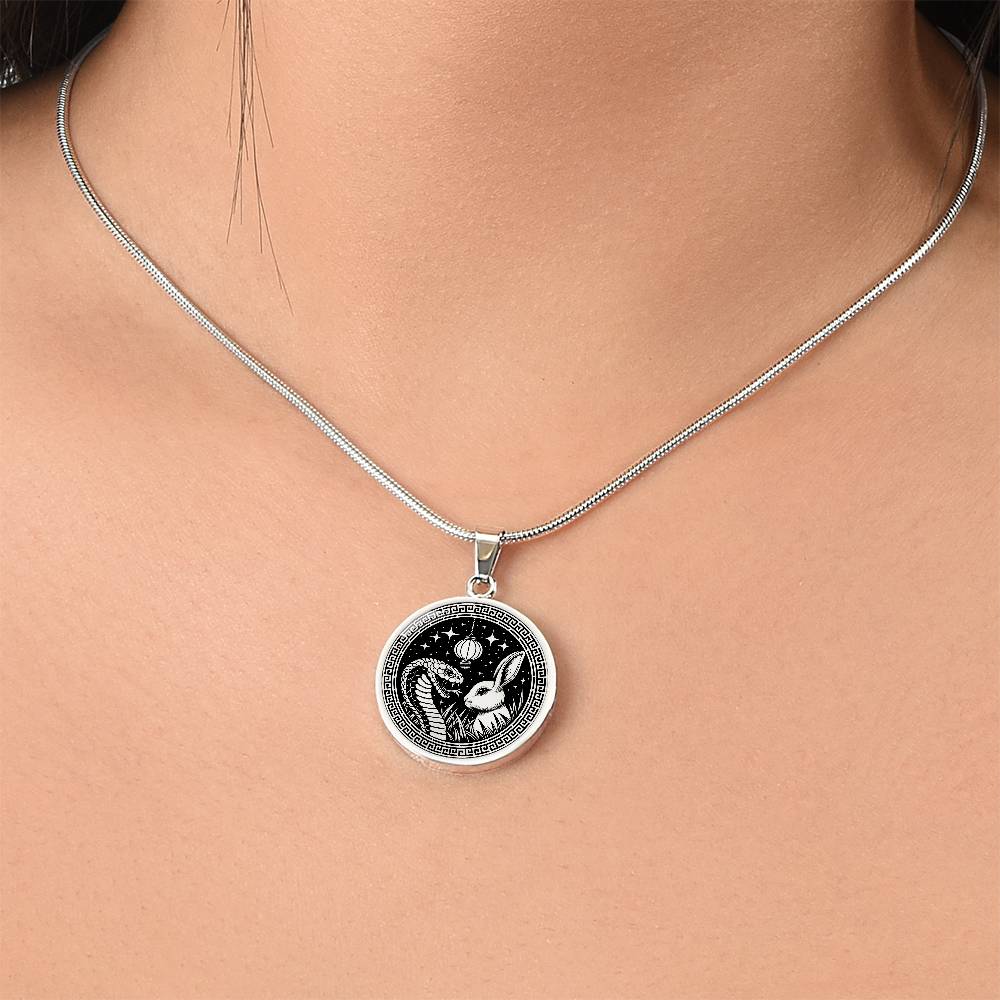 Woman wearing An Elegant silver pendant featuring a Year of the Rabbit and Year of The Snake Necklace in silver and black. This jewelry offers personalization with an engraving option for a name.