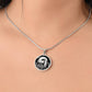 Woman wearing an Elegant silver pendant Water Lily Bunny necklace. Colors are silver with a black background. This jewelry offers personalization with an engraving option for a name.