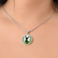 Woman wearing An Elegant silver pendant Deer Necklace. All in Silver and black with green leaves. This jewelry offers personalization with an engraving option for a name.