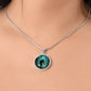 Woman wearing an Elegant silver pendant Bigfoot Necklace. Colors are Green, Brown, Black, Blue and White. This jewelry offers personalization with an engraving option for a name.