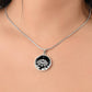 Woman wearing An Elegant silver pendant Water Lily Necklace featuring Stars, Lily Pads and a Water lily, all in black and silver. This jewelry offers personalization with an engraving option for a name.